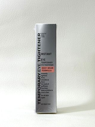 Temporary Eye Tightener in sleek silver packaging, designed to reduce puffiness and fine lines around the eyes.